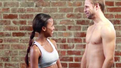 fit couple talking in crossfit gym