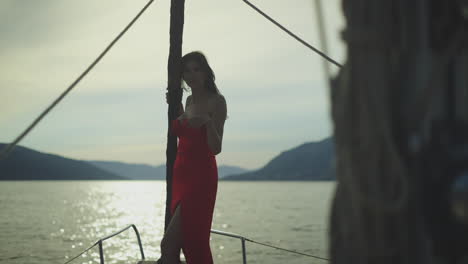 woman in red dress on a yacht at sunset