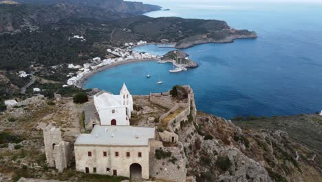 Vista-Cinematográfica-Orbital-Sobre-El-Castillo-De-Chora-Kythira-Y-La-Bahía-De-Kapsali,-Grecia.