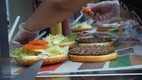 preparing burgers in a restaurant kitchen