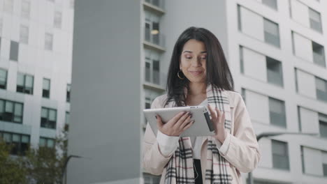 Businesswoman-reading-good-news-on-touchpad.-Smiling-girl-enjoying-success