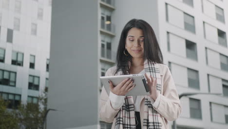 businesswoman reading good news on touchpad. smiling girl enjoying success