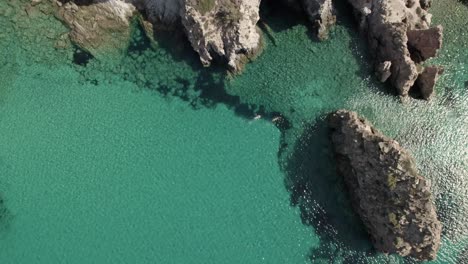 Two-people-swimming-in-crystal--clear,-turquoise-blue-Mediterranean-waters