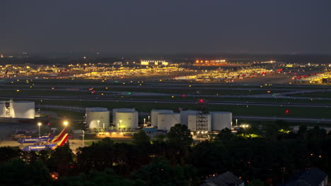 atlanta georgia aerial v892 hyperlapse capturing activities on the concourse, with planes taking off and landing on the runway at hartsfield airport at night - shot with mavic 3 pro cine - june 2023