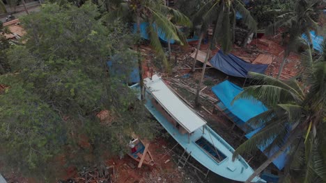 Top-down-view-of-boat-construction-at-Belitung-island-Indonesia,-aerial