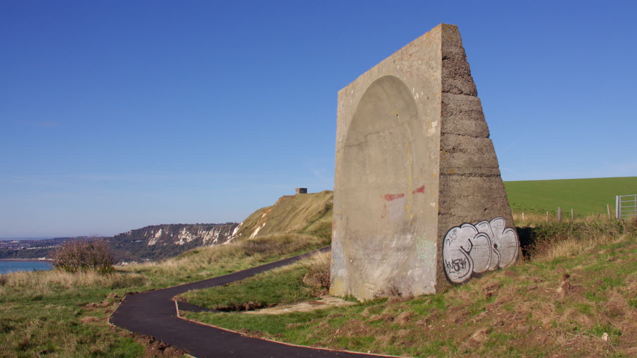 Wide panning shot right to left side on to the abbot's Cliff sound mirror. Next to Folkestone
