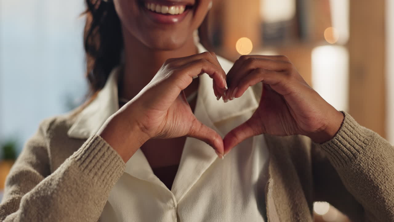 Woman making heart shape with hands