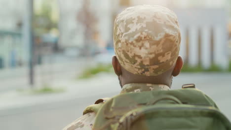 an soldier in uniform walks outdoors