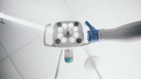 dentist adjusting a dental light