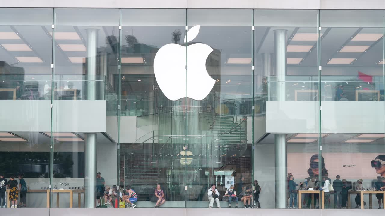 An establishing shot of customers shopping at the Apple Store, the American tech company, in Hong Kong.