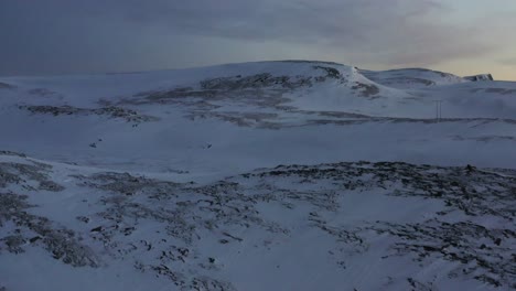 revealing shot of the wilderness in northern europe during winter, showing a windy frozen tundra