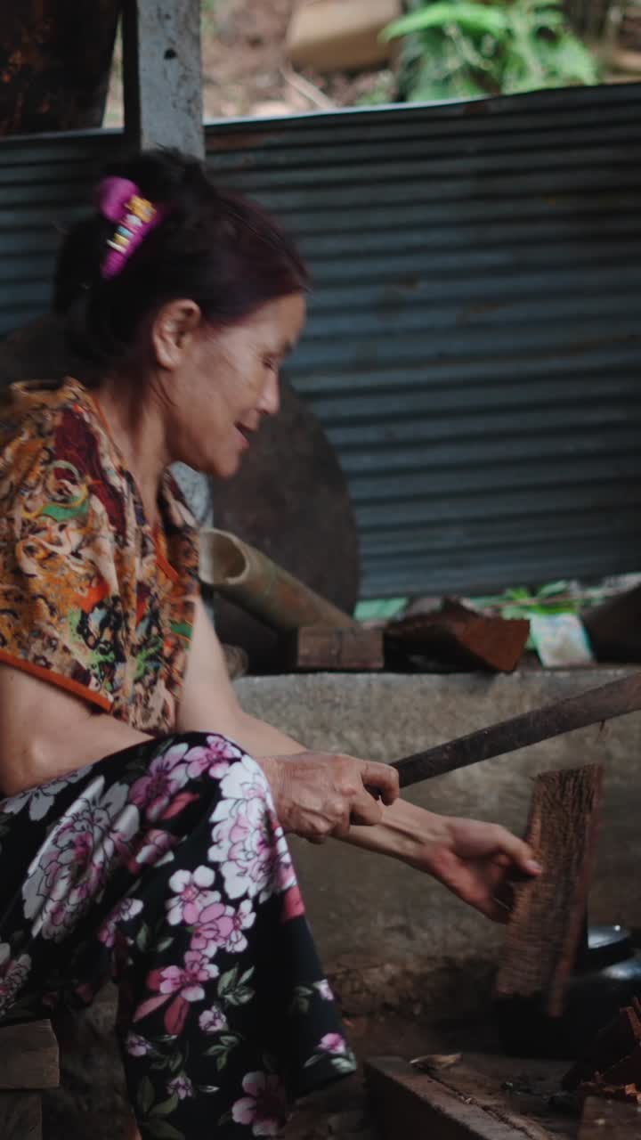 A woman preparing food using traditional methods
