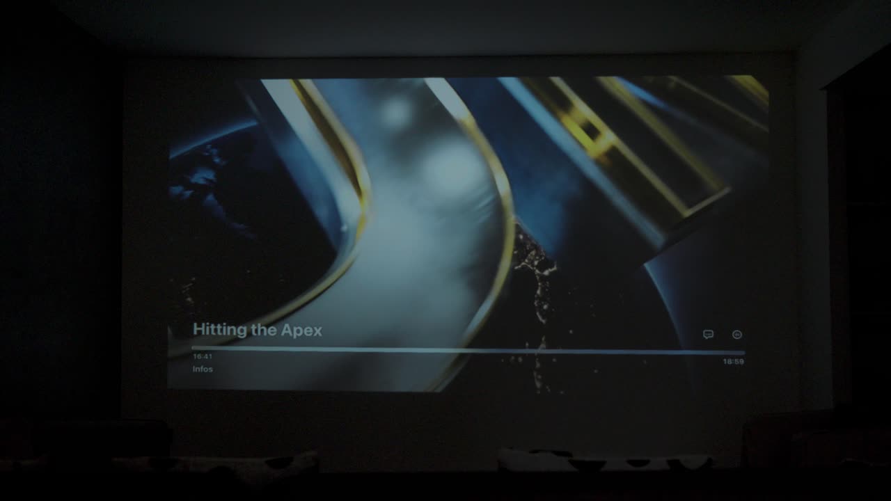 Slow motion shot of a movie being projected onto a cinema room within a villa