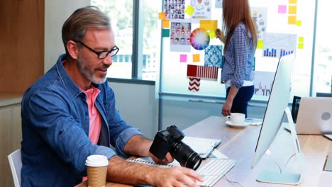 Male-graphic-designer-working-at-desk