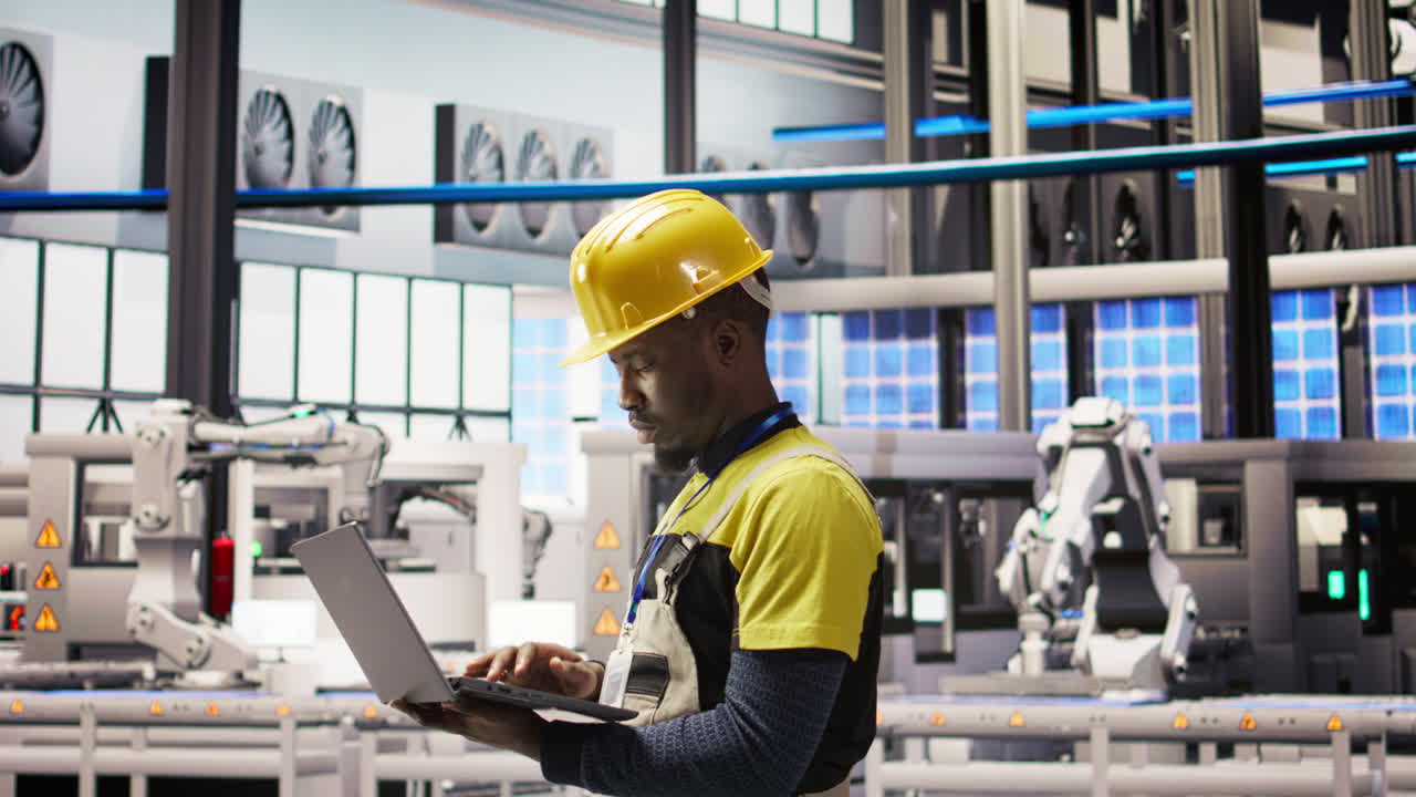 Vertical video Technician in smart factory using notebook to look at system performance metrics