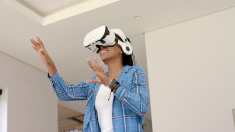 A-young-African-American-woman-wearing-VR-headset-dancing,-copy-space