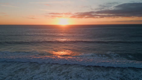 golden dawn sky serene ocean surf. aerial view sunset sea rippling water surface