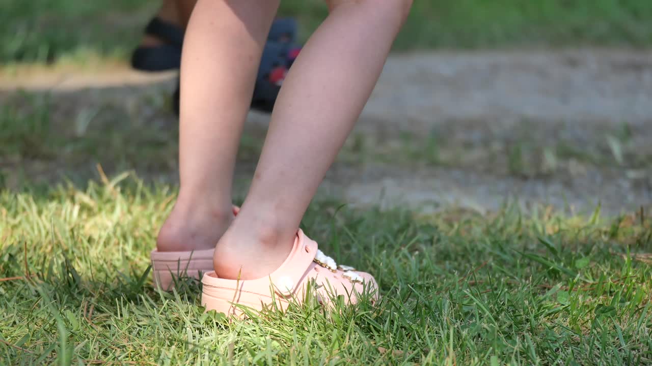 Legs and feet on grass