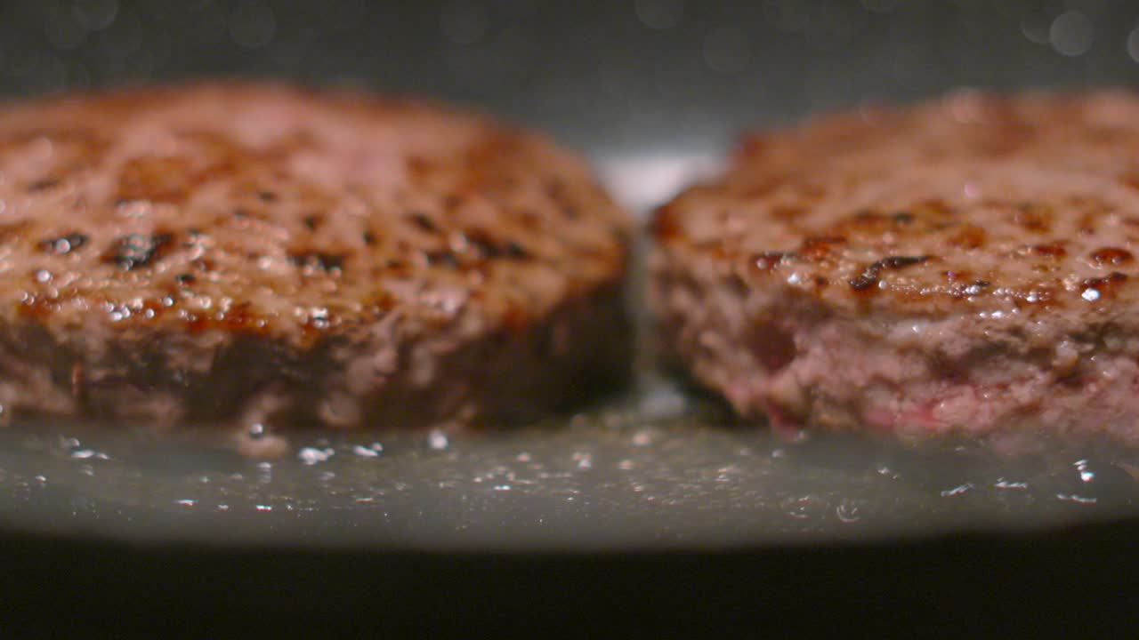 Preparing Fresh Beef Burgers in Hot Olive Oil Bubbling. Ground Minced Meat Cooking in Slow Motion