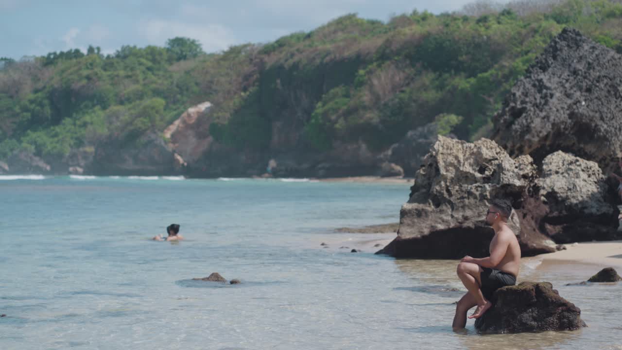 Man Relaxing on Beach Rocks
