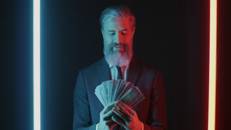 businessman holding money in neon light