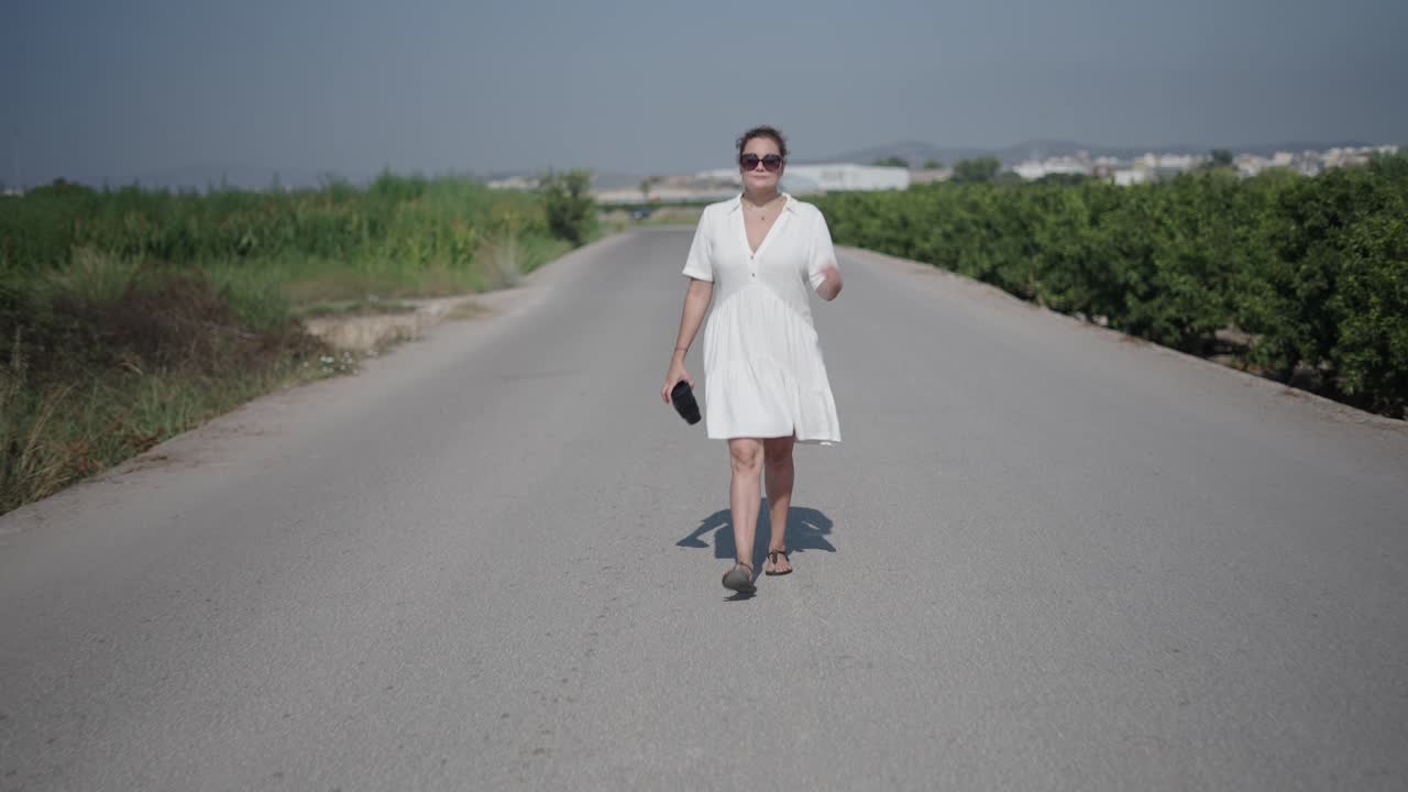 Donna che cammina su una strada di campagna