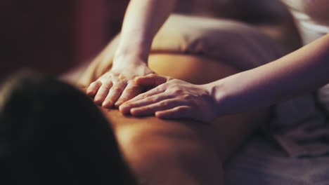 girl gets back massage at spa