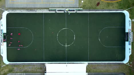 Aerial-overhead-shot-of-a-synthetic-grass-5-a-side-soccer-field-with-one-of-the-areas-being-used-for-training