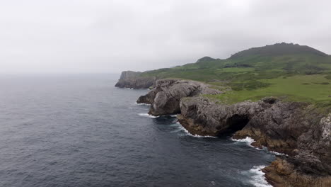 coastal cliffs and caves on a cloudy day