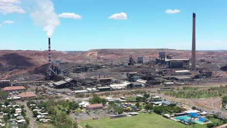 Excellent-Aerial-Shot-Of-Smokestacks-Towering-Over-Mount-Isa,-Australia