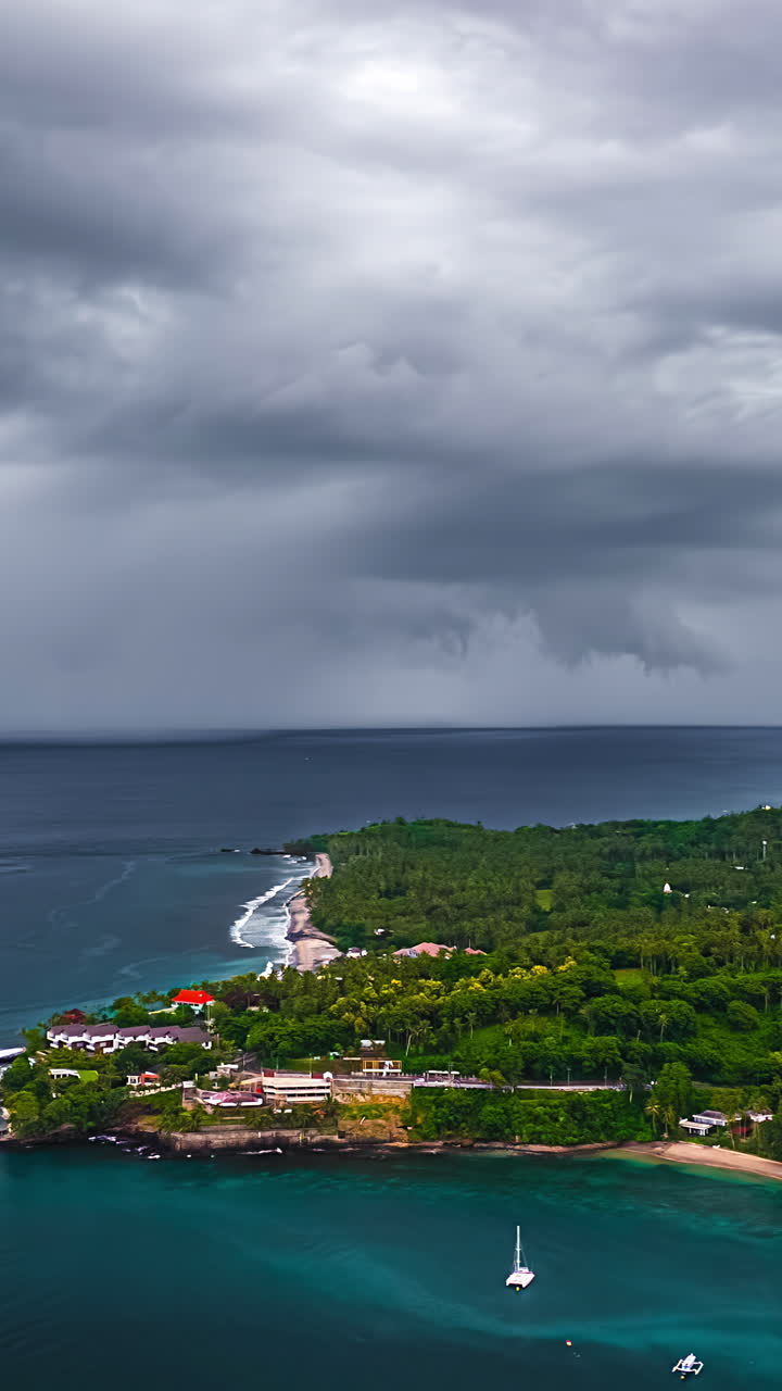 A Dramatic Sky Looms Over a Lush Coastline and Anchored Boats in Bali, Indonesia - Timelapse