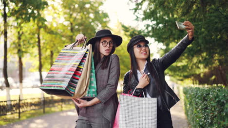 Two friends shopping in the park