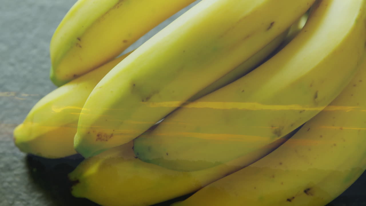 Stacking bananas with sunset landscape overlay creates vibrant animation effect