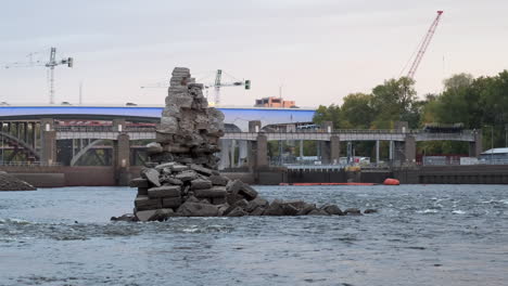 Mill-City-Rubble-In-The-Mississipi,-Future-Construction-In-The-Background