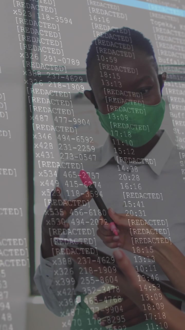 Animation of financial data processing over diverse businesswomen with face masks taking notes