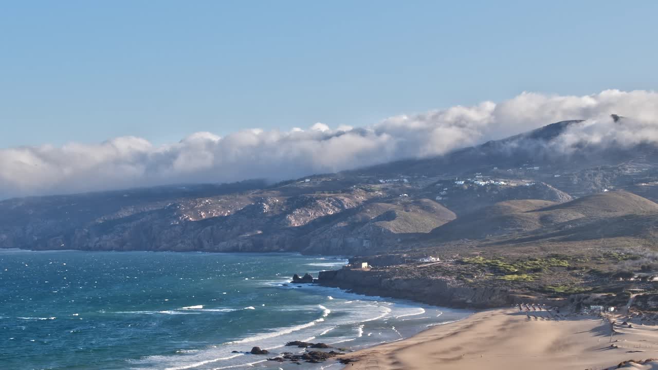 Coastal view of Portugal with mountains and clouds by the beach