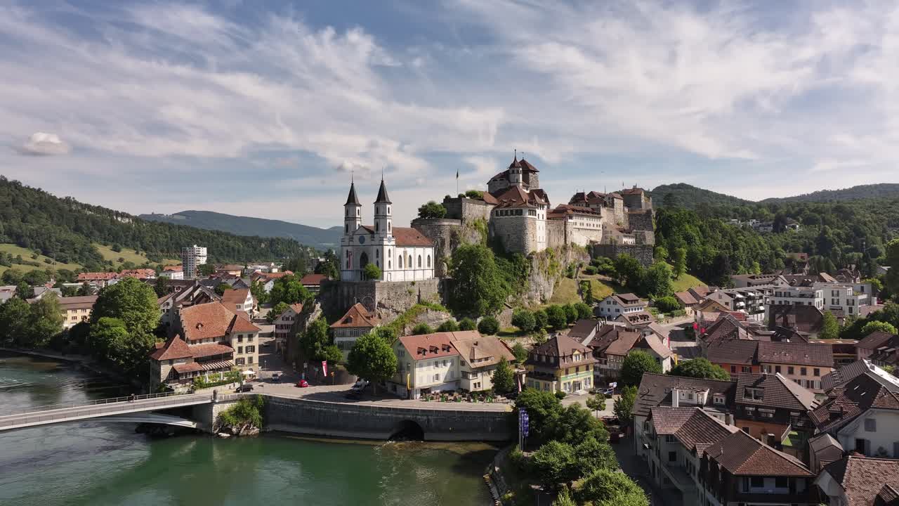 Aarburg castle and church on rocky hill beside Aare river in Switzerland, stunning drone aerial view