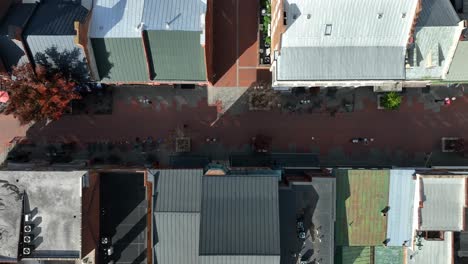 Top-down-aerial-view-of-pedestrian-cobblestone-street-with-shops