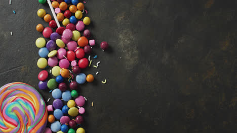 Video-of-colourful-lentils-and-lollipop-on-grey-background