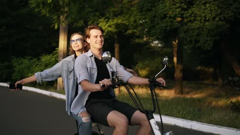 Pareja-Feliz-Y-Sonriente-Montando-Bicicleta-Eléctrica-En-El-Parque