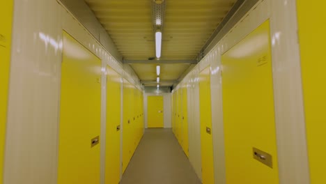 a quick point-of-view walk through a corridor with endless yellow doors in a self-storage warehouse