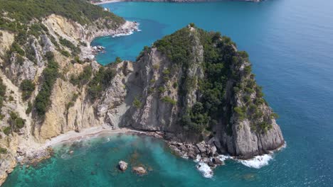 aerial, tilt down view over rocky cliff beach with no people, corfu, greece, slow-motion