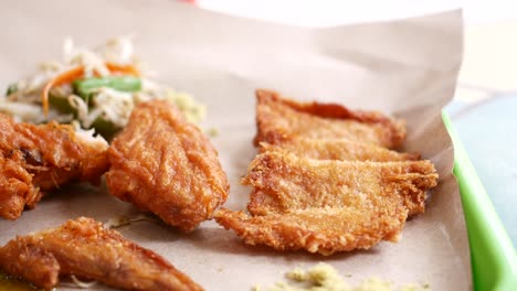 crispy fried chicken wings on a plate top view