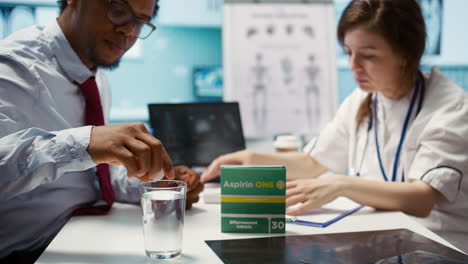 specialist giving an effervescent vitamin to patient in medical office