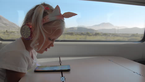 kid watching mobile video during the train ride