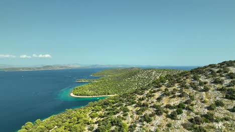 calm drone dolley shot over zmajan island coast line in croatia on sunny summer day