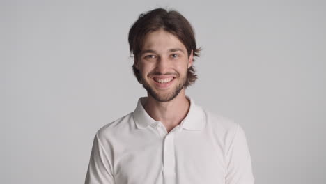 Caucasian-surprised-man-in-front-of-camera-on-gray-background.