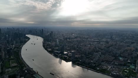 drone aerial view of buildings, cityscape and river in downtown