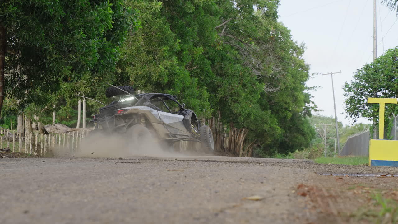 Dirt Buggy Skidding Onto Road And Driving Off Into The Horizon In Punta Cana In Dominican Republic. Slow Motion, Tracking Shot