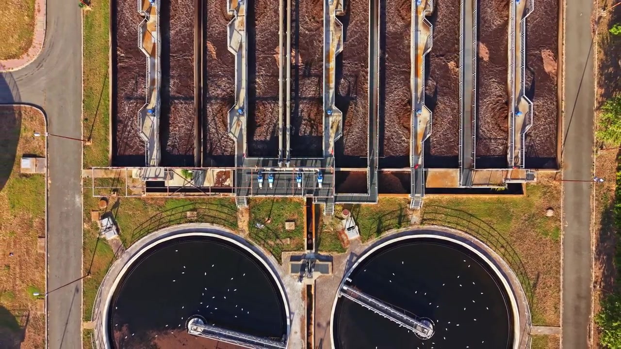Water treatment facility shows water cleaning process with multiple treatment tanks and pipelines